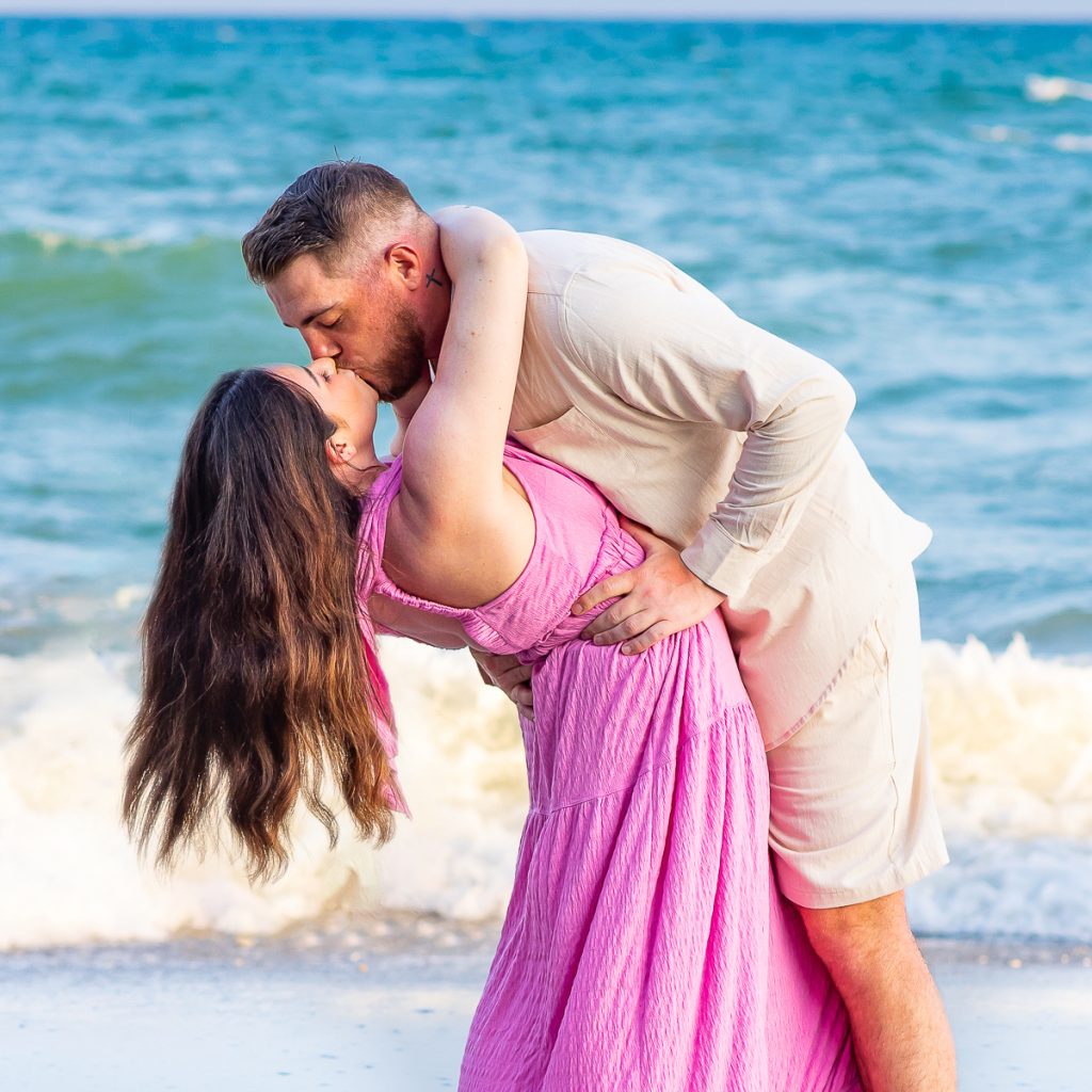 A beautiful couple kissing on the beach in Myrtle Beach, SC for myrtle beach photographer beachmonkey photography.